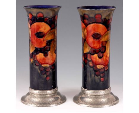 A LARGE PAIR OF WILLIAM MOORCROFT POMEGRANATE CYLINDRICAL VASES WITH PEWTER BASES tube lined and decorated with a continuous 