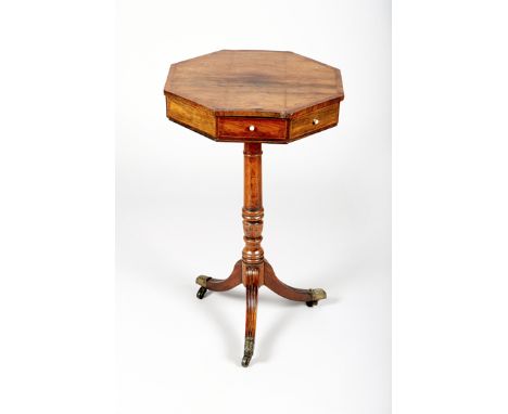 Rosewood octagonal topped pedestal table with four fitted drawers on central turned pedestal on tripod feet brass caps and ca