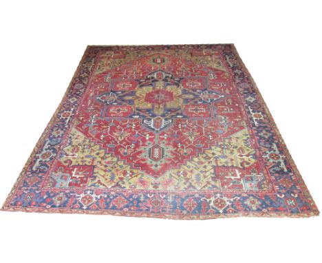 ANTIQUE HERIZ CARPET, 340cm x 265cm, geometric pole medallions on a terracotta field of scrolling vines inside old gold spand