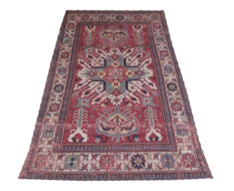 ANTIQUE EAGLE KAZAK CARPET, 200cm x 122cm, geometric medallions and stylised trees on a terracotta field inside a correspondi