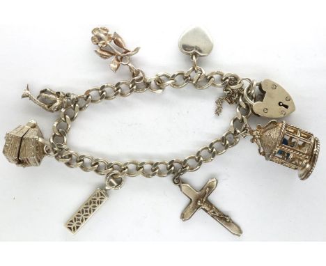 925 silver charm bracelet with seven charms, L: 18 cm. P&amp;P Group 1 (£14+VAT for the first lot and £1+VAT for subsequent l