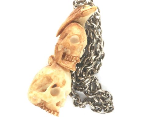 Meerschaum skull and dolphin form pendant, on a 925 silver neck chain, chain L: 44 cm. P&amp;P Group 1 (£14+VAT for the first