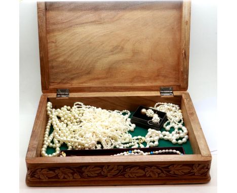 Natural and synthetic pearl necklaces, including Baroque examples, within a carved wooden box. P&amp;P Group 1 (£14+VAT for t