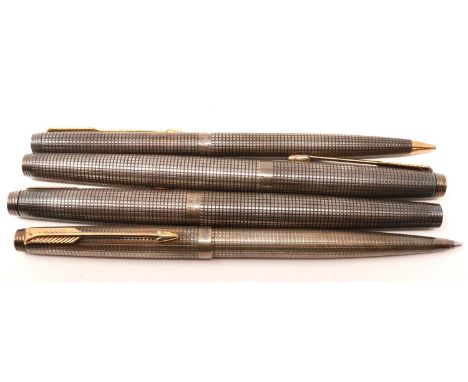 Three Parker pens comprising fountain, ballpoint and another (damaged), with a matching propelling pencil, all in sterling si