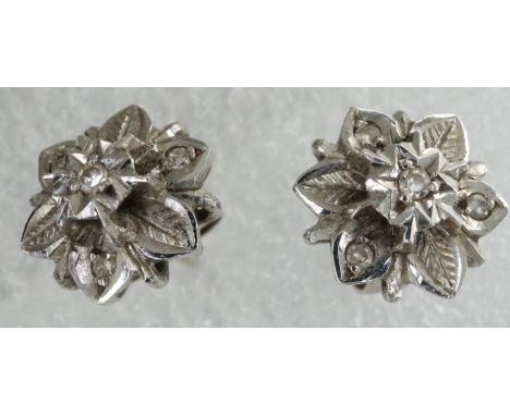 Pair of 18ct white gold diamond set flower stud earrings, 2.9g. P&amp;P Group 1 (£14+VAT for the first lot and £1+VAT for sub