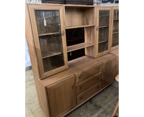 An Ercol elm glazed bookcase, width 155cm depth 44cm height 162cm