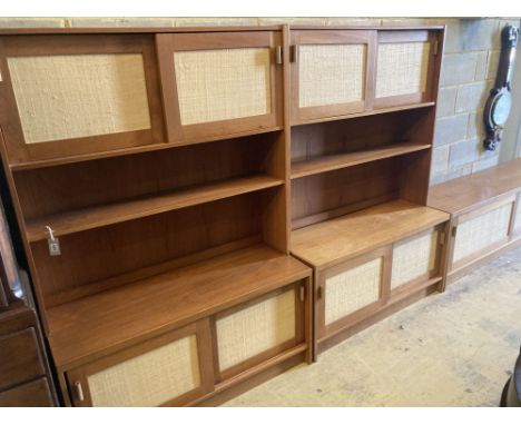 Three near-matching teak side cabinets, each free standing upper section fitted a pair of cupboard doors over an open shelf, 