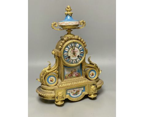 A Louis XVI ormolu mantel clock inset Sevres style panels, height 38cm