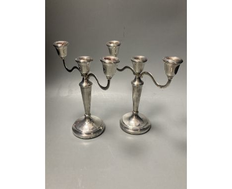 A modern pair of silver two branch, three light candelabra, Birmingham, 1988, 21.1cm, weighted.
