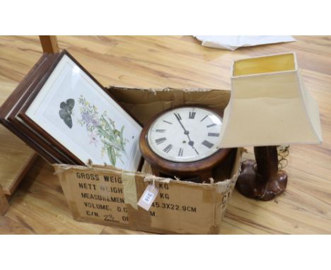 A dial clock, a carved wood table lamp and four prints