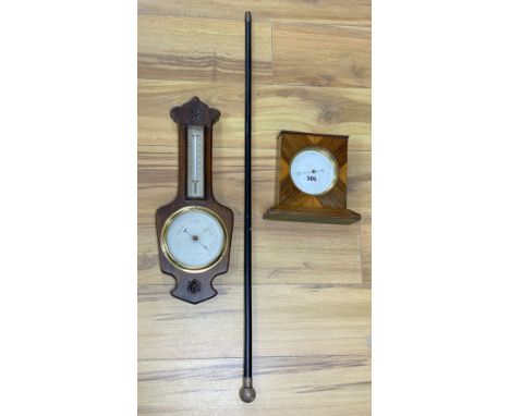 A Victorian silver mounted cane, a wheel barometer and a mantel barometer