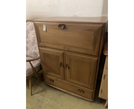 An Ercol elm drinks cabinet, fitted fall flap over cupboards and drawer, width 82cm depth 44cm height 110cm