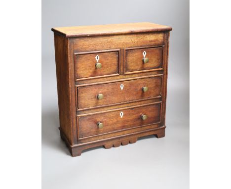A miniature mahogany chest of drawers, height 33cm