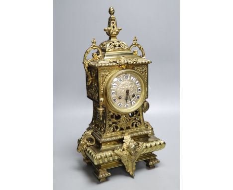 A French brass rococo-style mantel clock, with key and pendulum