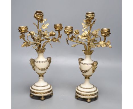 A pair of gilt metal and alabaster three branch candelabra, height 31cm (one a.f.)CONDITION: The gilding in places has tarnis