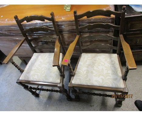 A pair of modern oak ladder back dining chairs, raised on bobbin turned, block legs