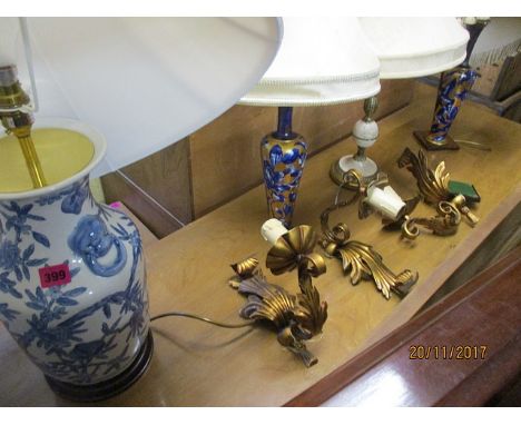 Lighting to include three china table lamps, a brass and marble table lamp and three gilt metal wall lights