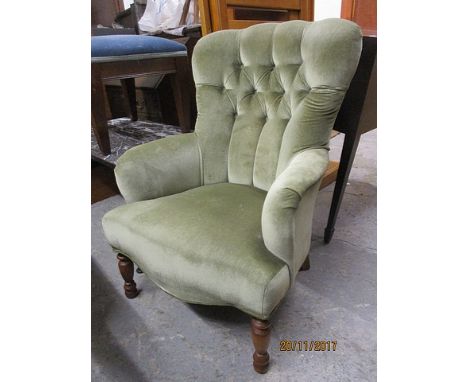 A modern green dralon, button upholstered armchair, raised on turned, tapering beech legs