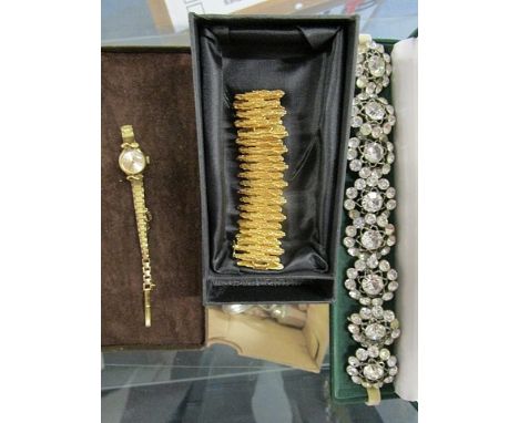 Circa 1970s a gilded, white metal bracelet, a set of eight buttons set with paste stones and a Rotary gold plated ladies wris
