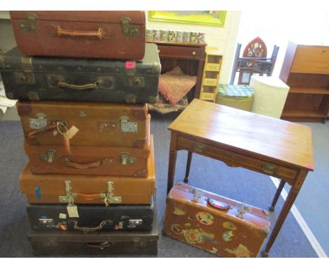 A collection of eight vintage suitcases to include leather suitcases