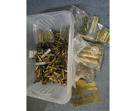 A selection of bullet shell cases, two brass button slides and a trench art cap