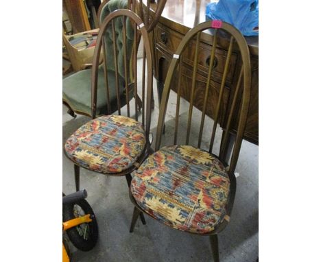 A set of eight mid 20th century Ercol dark elm and beech stick back chairs