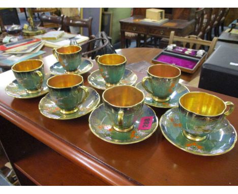 A Carlton ware enamelled part coffee set, comprising seven coffee cans with saucers