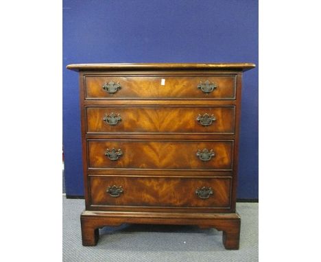A reproduction mahogany chest with four graduated long drawers on bracket feet, 29 x 27