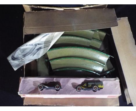 A boxed vintage German tinplate By-Pass Traffic Play Set. The set has two clockwork tinplate cars along with a series of tinp