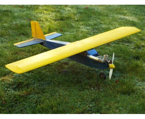 A remote control model aircraft with fuel engine. Wingspan measures approximately 126cms. The aircraft is missing a remote co
