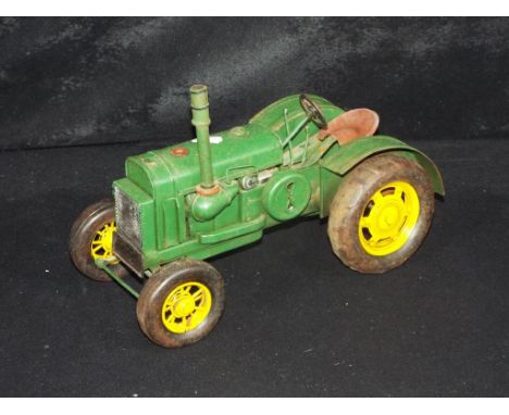 A tin plate model of a Farm Tractor, measuring approximately 30cms in length. The model is unboxed. This lot must be paid for