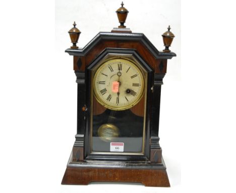 A late 19th century faux rosewood and ebonised cased mantel clock having a painted dial with Arabic numerals bearing a label 