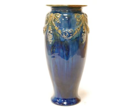 An early 20th century Royal Doulton vase on a mottled blue ground with swag and bow decoration impressed lion and crown mark 