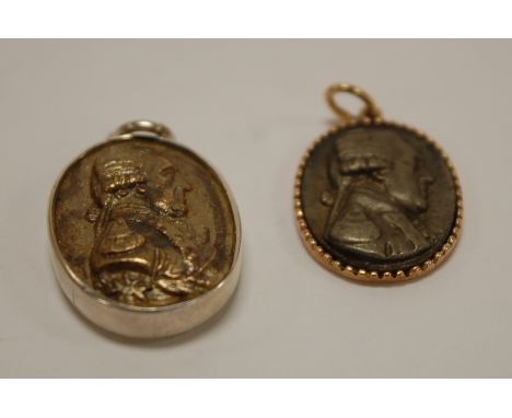 A reproduction silver pendant medallion depicting profile portrait of Napoleon together with one other gold backed example (2