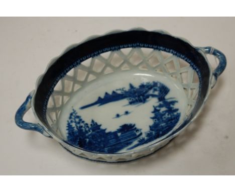 A late 19th century porcelain chestnut basket, the central panel depicting a Chinese landscape within the lattice work border