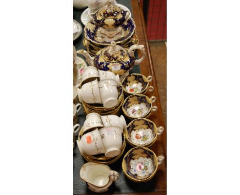 A Victorian part tea and dinner service, having hand painted floral decoration within a gilt heightened blue border  Conditio