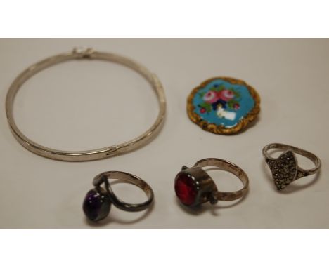 A  silver and CZ set hinge bangle together with a silver marcasite ring, two other white metal dress rings, and an enamel set