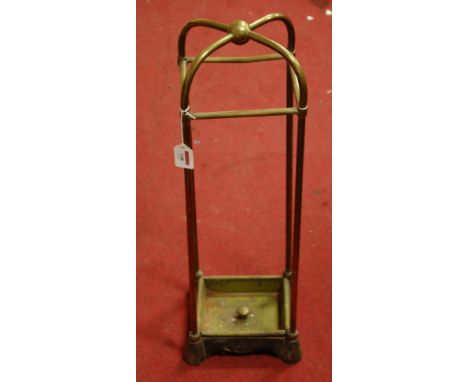 An early 20th century lacquered brass stick stand on cast iron base