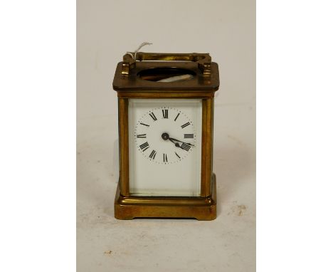A mid-20th century brass cased carriage clock, having enamel dial with Roman numerals and visible platform lever escapement