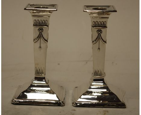 A pair of early 20th century silver table candlesticks in the neo classical style, height 13cm Condition Report / Extra Infor