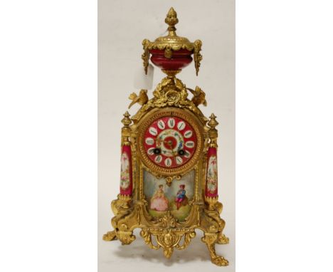 An early 20th century French gilt metal mounted and porcelain inset mantel clock having an enamel dial with Roman numerals an
