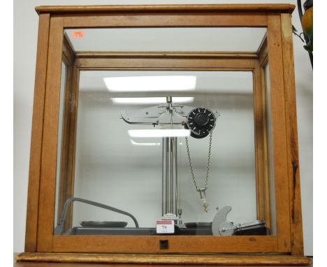 A set of Griffin & George laboratory scales in an oak framed display case