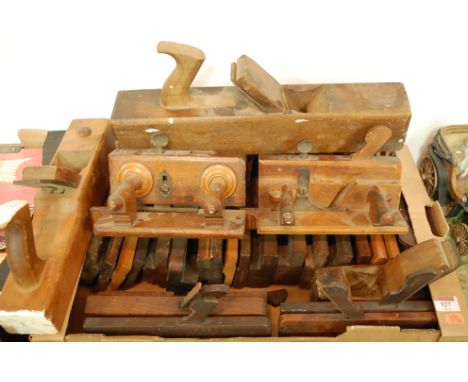 A box of assorted wooden hand tools to include moulding planes 