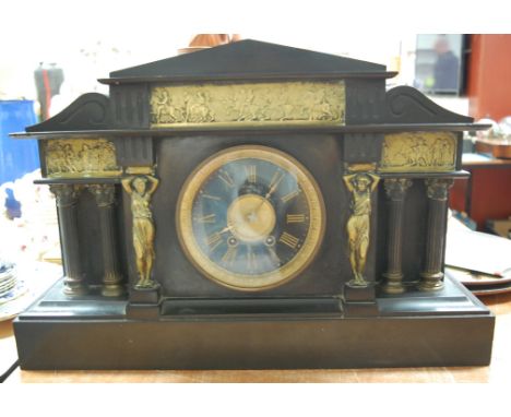 A large late Victorian black slate and brass mounted mantel clock, of architectural form, having matt dial with gilt Roman nu