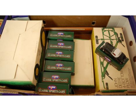 A boxed Ertl John Deere toy tractor; together with a boxed John Deere four-bottom plough; and various boxed Corgi Classics sp
