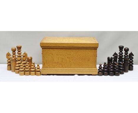 A TURNED AND CARVED WOOD GARDEN CHESS SET (King 23cm high), in a craftsman made oak storage trunk with brass drop handles and