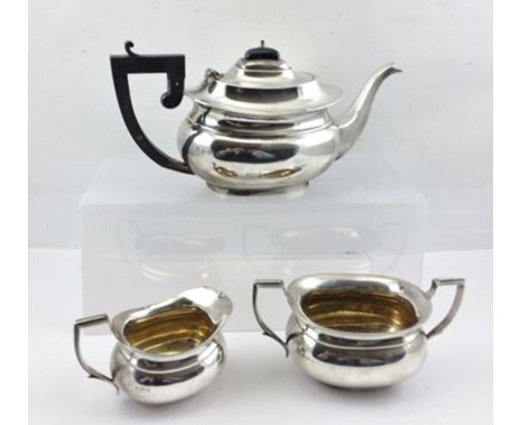 A GEORGIAN DESIGN THREE-PIECE SILVER TEA SET, comprising teapot, milk jug and a two-handled sugar bowl, Birmingham 1932, tota