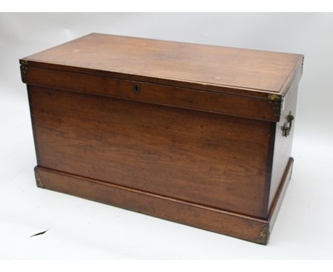 A 19TH CENTURY MAHOGANY STORAGE TRUNK, having hinged lid, with decorative brass mounts and side fitted carrying handles, 55cm