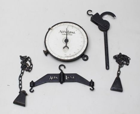 A CAST IRON STABLE MOUNTING HAY RACK, painted black and an "ALFA-LAVAL CHURN RECORDER" having circular calibrated dial with c