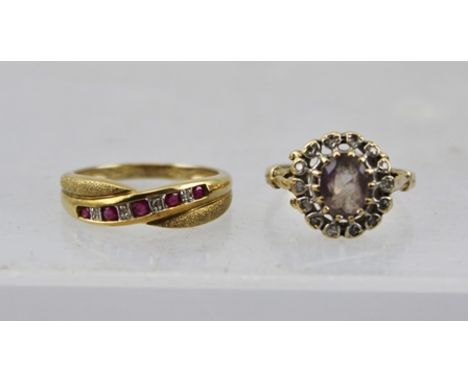 A 9CT GOLD LADY'S RING, set a central amethyst surrounded by diamonds, size N, together with a RUBY AND DIAMOND SET RING, siz